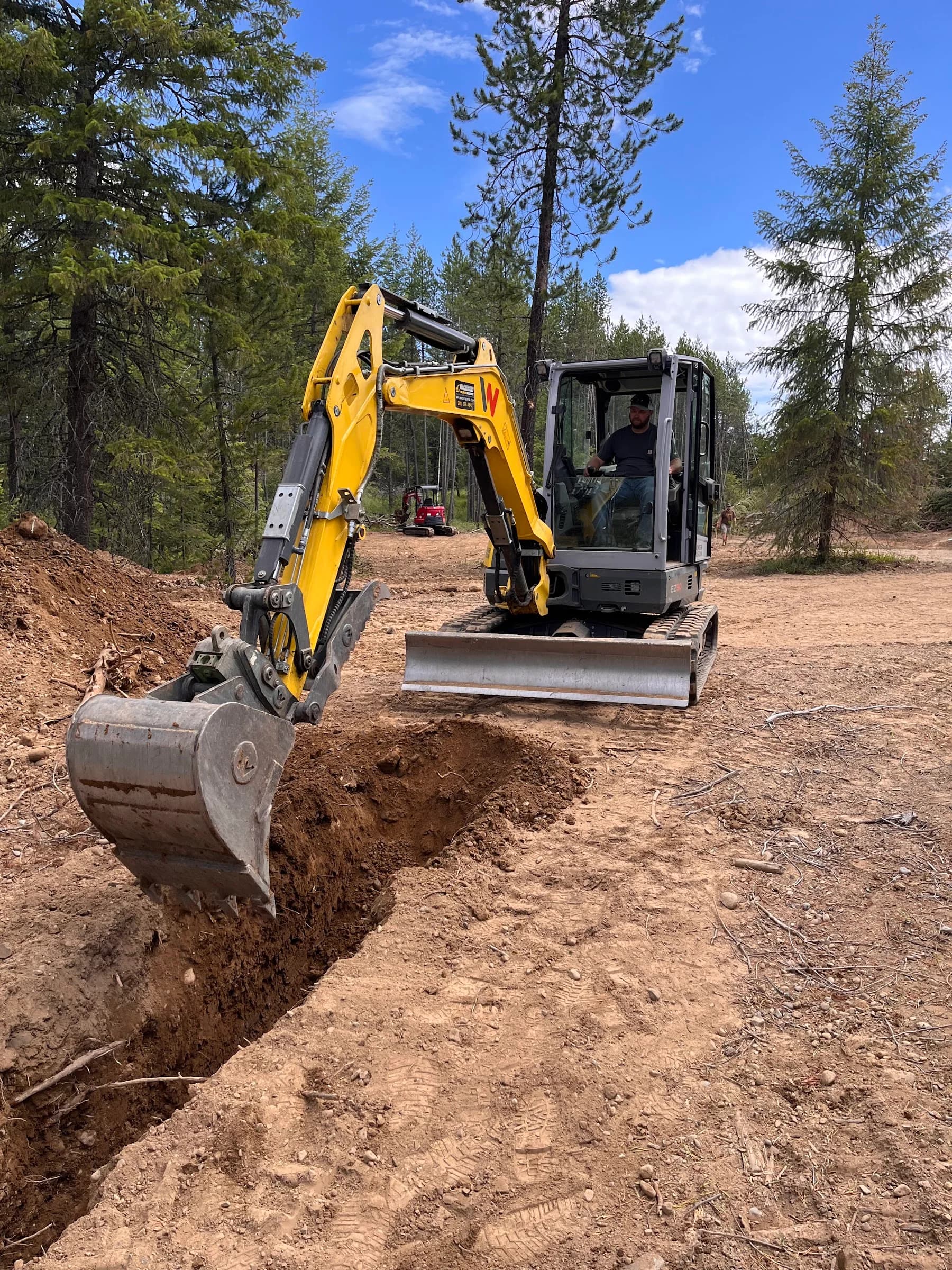 Front view of an excavator working along a trench