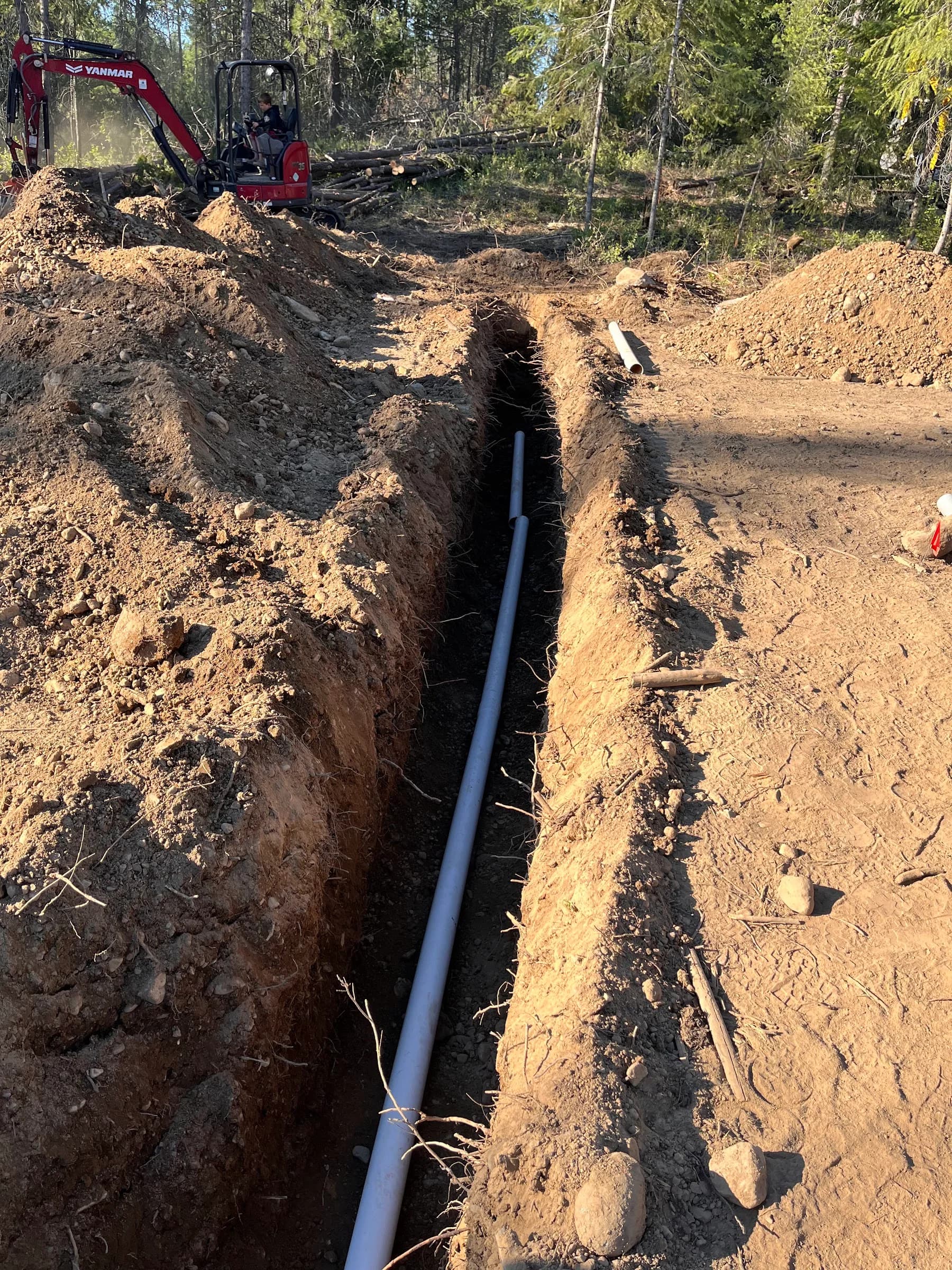 Pipe visible along the bottom of an open trench